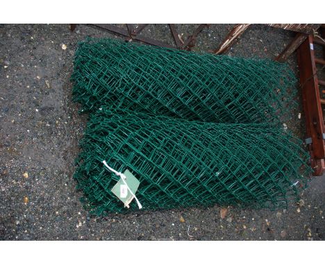 Two rolls of plastic coated chain link wire.