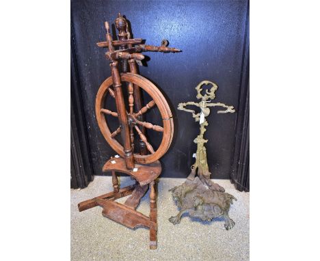 A decorative French brass stick stand; a spinning wheel