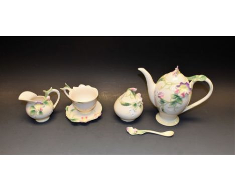 A Franz porcelain sweetpea pot, sucrier, creamer, cup and saucer, teaspoon, all boxed 