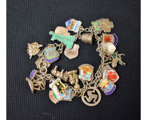 A silver charm bracelet, 27 charms, mostly silver and enamel