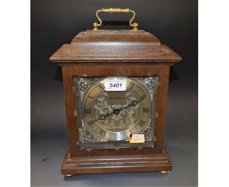 A contemporary Fox & Simpson oak cased bracket clock, silvered dial and spandrels, Roman numerals, bell chiming movement, fol