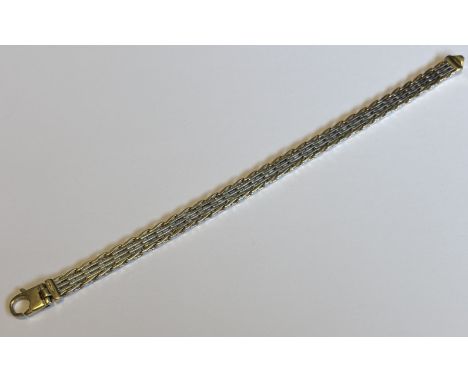 A 9 carat two-colour gate bracelet. Approx. 22.5 grams. Est. £580 - £620.