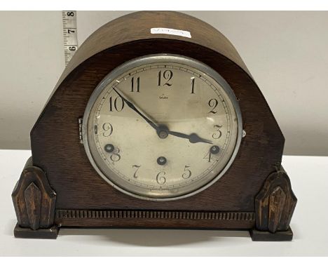 A wooden cased mantle clock by The Widex Company with pendulum (untested), shipping unavailable