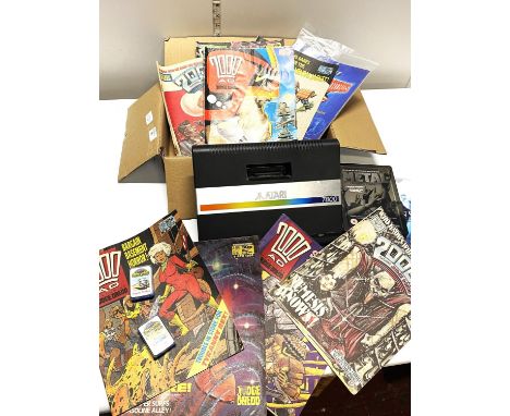 A box of assorted items including Atari 7800 console (untested) and PS games and comics, shipping unavailable