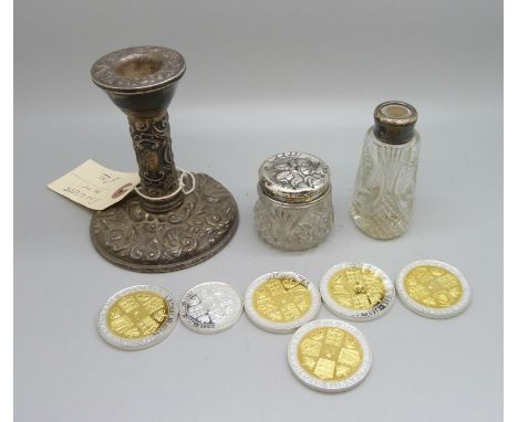 A silver candlestick, silver topped jar decorated with Reynolds Angels, silver topped bottle, lacking stopper, and six proof 