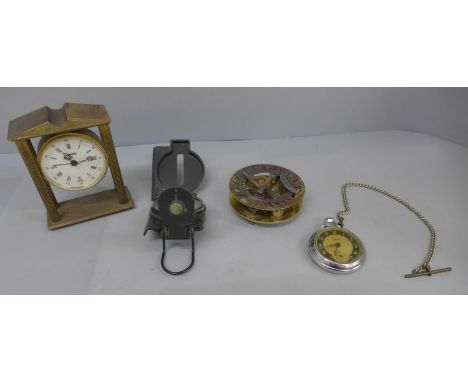 A compass, pocket watch, clock and brass compass with sun dial 