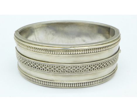 A Victorian white metal bangle, tests as silver