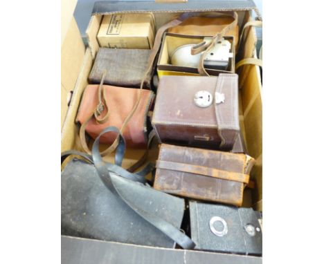 A box of vintage cameras, mainly box cameras but include Polaroid, Isoflex, Halina Prefect and others