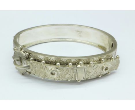 A Victorian white metal buckle bangle, tests as silver