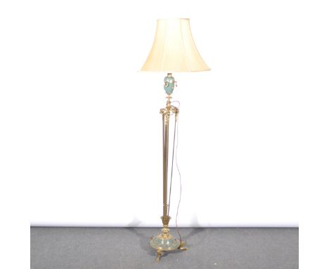A brass standard lamp, in the Neo Classical taste, designed with an urn, over a slender tripod, with rams heads and swags, ov