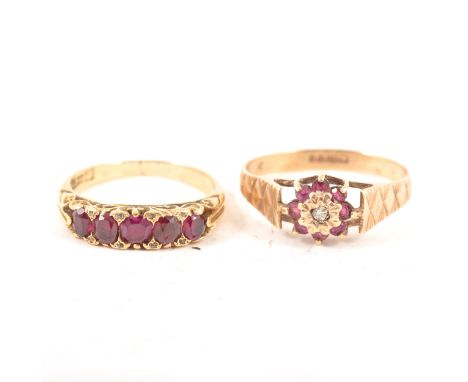 A ruby five stone ring, four oval and one cushion shaped ruby claw set in an all yellow metal carved claw mount marked 18ct, 