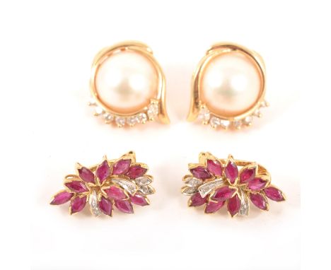 Two pairs of earrings for pierced ears, a pair of ruby cluster earrings with eleven marquise cut rubies and four diamond poin