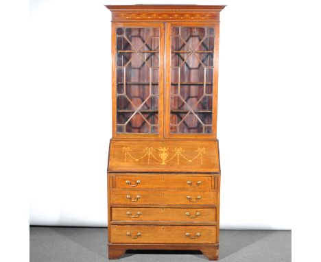 An Edwardian inlaid mahogany bureau bookcase, the frieze inlaid with fruitwood garlands, above astragal glazed doors enclosin