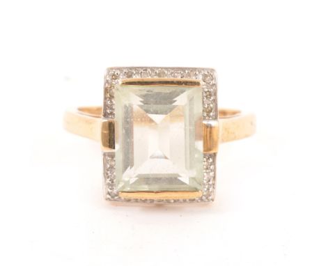 A mint quartz and diamond ring, rectangular step cut quartz 11mm x 9mm, surrounded by twenty-two 8 cut diamonds in a 9 carat 