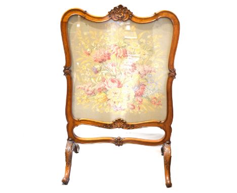 Victorian walnut framed firescreen, carved serpentine frame, inset with a woolwork panel, width 78cm, height 125cm.