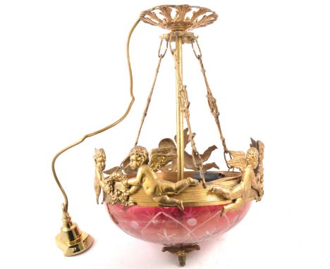 Brass hanging light fitting, cherub designed frame, ruby tinted glass shade, 45cm drop.