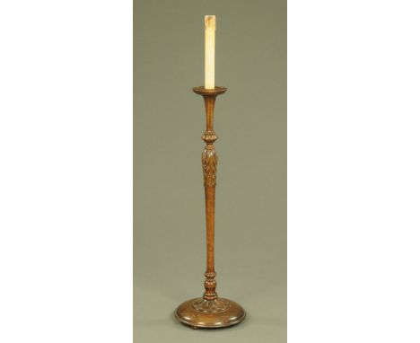 A walnut lamp standard, with candle top and fluted and carved column with circular base.  Height 137 cm.