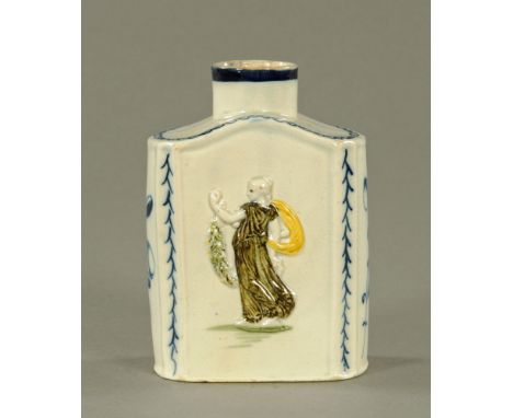 An 18th century pearlware pottery tea caddy, decorated in underglaze blue with leaves and moulded in relief and decorated in 