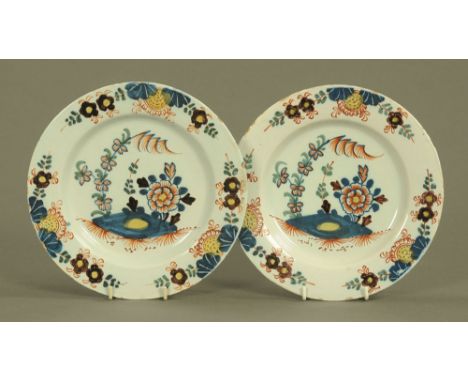 A pair of late 18th century tin glazed earthenware plates, decorated with flower heads.  Each diameter 23 cm (see illustratio