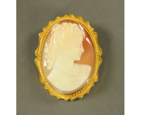 A 9 ct gold mounted cameo brooch, with profile portrait and ornate mount, stamped 9 ct, gross weight 16 grams, height 5.5 cm,