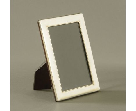 A silver photograph frame, with easel back, 1996, maker Carrs of Sheffield, frame outer dimensions 18.5 cm x 13.5 cm. CONDITI