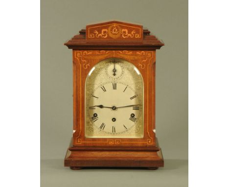 An Edwardian inlaid mahogany bracket clock, with silvered dial and three train spring driven movement striking on five gongs,