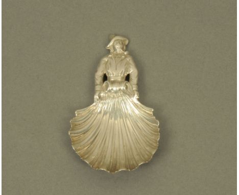 A cast white metal caddy spoon, with fisherman figural terminal and scalloped bowl, bears hallmarks for London 1860, but poss