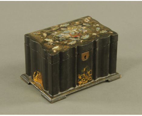 A Victorian black papier mache rectangular tea caddy, of shaped outline, the top inset with mother of pearl and decorated wit