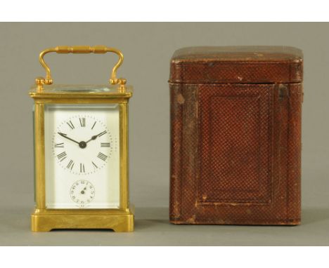 A French brass carriage clock, timepiece with alarm with Roman numerals, complete with carrying case.  Height excluding handl