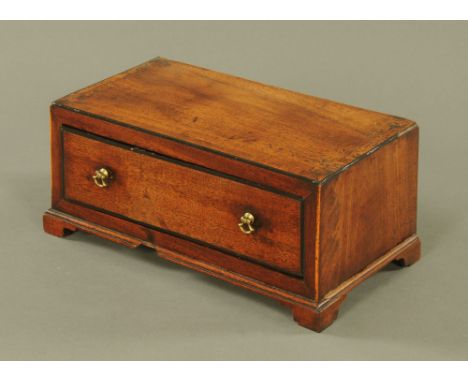 A George III mahogany single drawer box, with crossbanded top and drawer front, on bracket feet.  13 cm high x 30 cm wide x 1