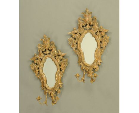 A pair of Florentine style giltwood and gesso girandole mirrors, each with bevelled glass, first half 20th century.  Height 7