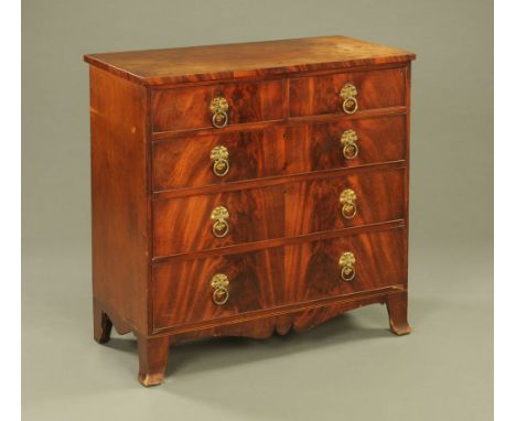 A 19th century mahogany chest of drawers, two short and three long with brass drop handles with embossed circular backplates 