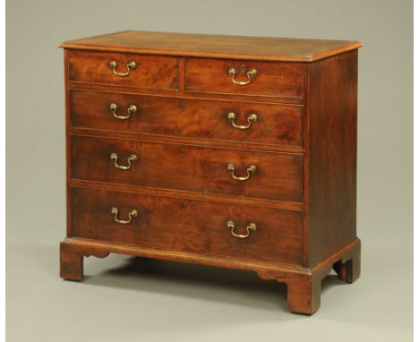 A George III mahogany chest of drawers, with moulded edge above two short and three long graduated drawers with brass swans n
