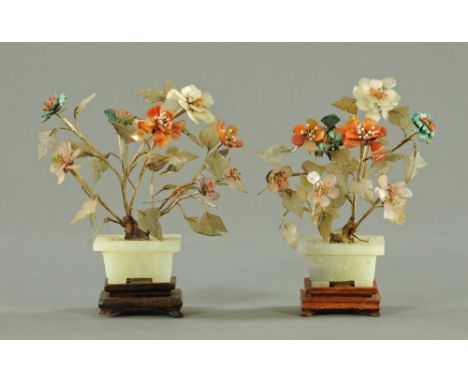 A pair of Chinese jade and hardstone models of trees, in square planters and on hardwood stands, each 20 cm high. CONDITION R