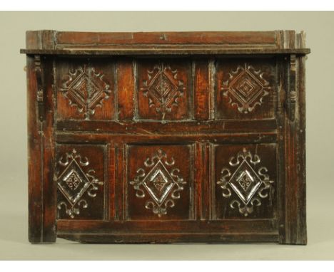 A section of 16th century oak Wainscot panelling, the six panels carved with lozenge and scrolled motifs, fitted with later s