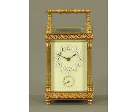 A brass carriage clock, timepiece with alarm, with Arabic numerals and subsidiary alarm dial.  Height including handle 14 cm.