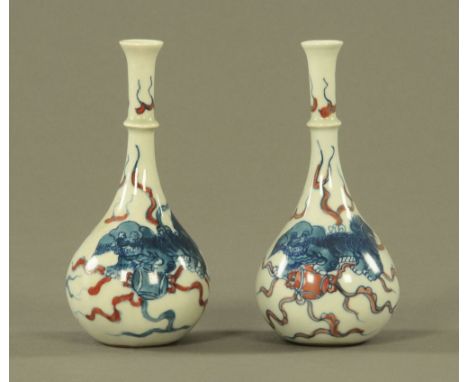 A pair of Chinese porcelain miniature vases of Kangxi style, decorated in blue and underglaze iron red with Kylins and with A