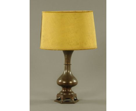 A 19th century Chinese bronze vase, of baluster form, with open base, converted to a table lamp, with shade.  37.5 cm. CONDIT