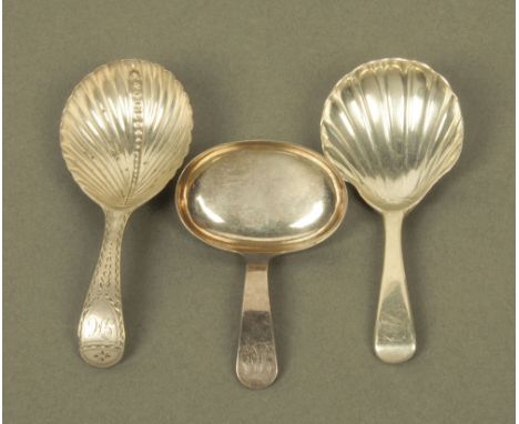 A George III silver caddy spoon, with engraved old English terminal, the scalloped bowl with central bead line, probably by W