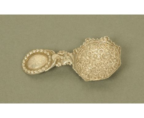 A George IV silver form caddy spoon by John Thropp or Joseph Taylor, with oval laurel wreath cast terminal and floral embosse