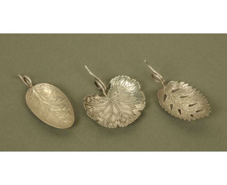 Three George III silver leaf form caddy spoons by Matthew Linwood, with scrolled terminals, Birmingham 1804-1807. CONDITION R