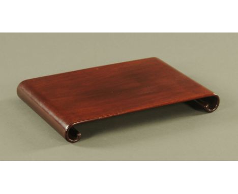 A Chinese Huanghuali scroll form table stand, 4.5 cm high, 34 cm wide, 22 cm deep. CONDITION REPORT: This piece is in extreme