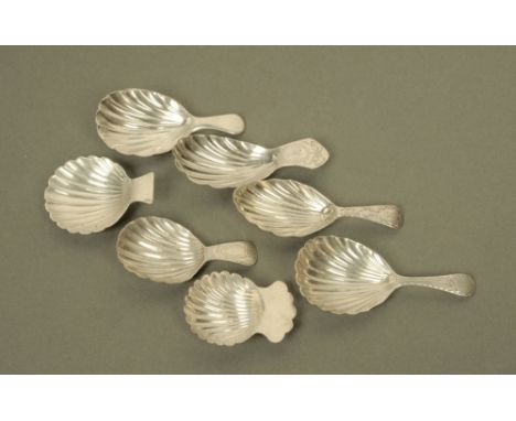 Seven George III and later silver caddy spoons, with short terminals and scalloped bowls, various dates and makers, some inco