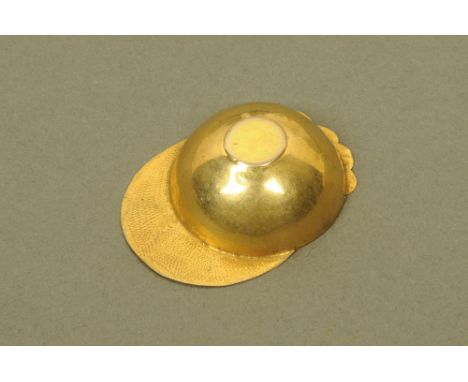 An early 19th century gold coloured metal jockey cap caddy spoon. CONDITION REPORT: This jockey cap spoon has a creased rim w