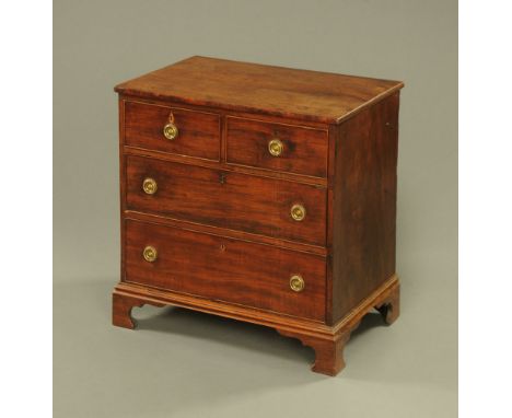 A 19th century mahogany chest of drawers, with moulded edge above two short and two long drawers with brass drop handles with