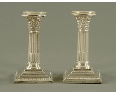 A pair of silver candlesticks, with detachable sconces, Corinthian capitals and square stepped beaded bases, Sheffield 1897, 