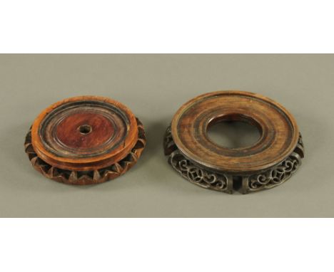 A Chinese rosewood circular vase stand, with fretted sides, 3.5 cm high x 16.5 cm diameter, and another Chinese vase stand, 1