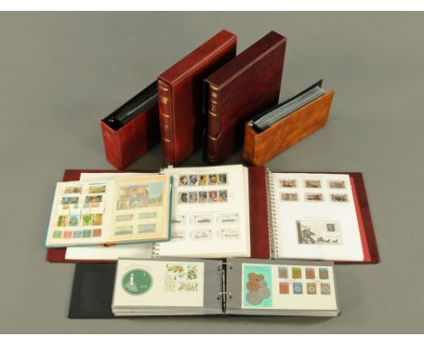 A collection of Guernsey Channel Island stamps, three albums of First Day Covers, four Stanley Gibbons albums of mint stamps 