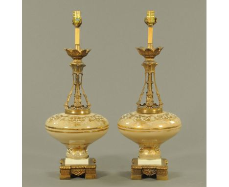 A pair of brass and glass table lamps, with square bases each raised on four short feet.  Height to top of light fitting 75 c