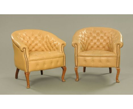 A pair of leather upholstered armchairs, deep buttoned raised on short cabriole front legs.  Height to top of back 77 cm, wid